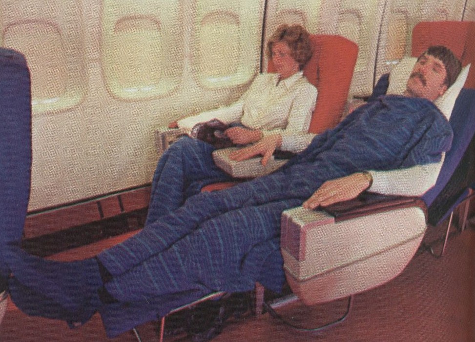 1980 Pan Am Passenger Service Agent, Al Donchenko, posing as a sleeping passenger for a publicity shot of Pan Am's Sleeperette seats in the First Class cabin of a Boeing 747SP.